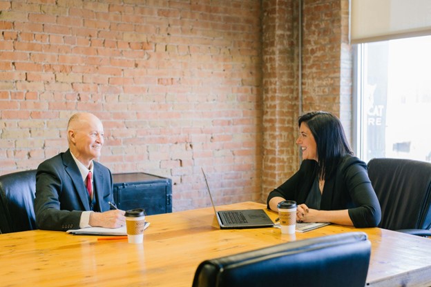 Woman talking to a man in a suit.